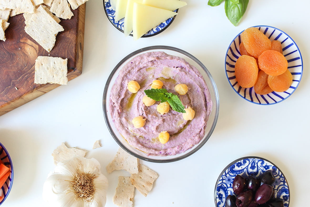Homemade purple healthy wild Arctic Flavors blueberry hummus served with appetizers, also called meze
